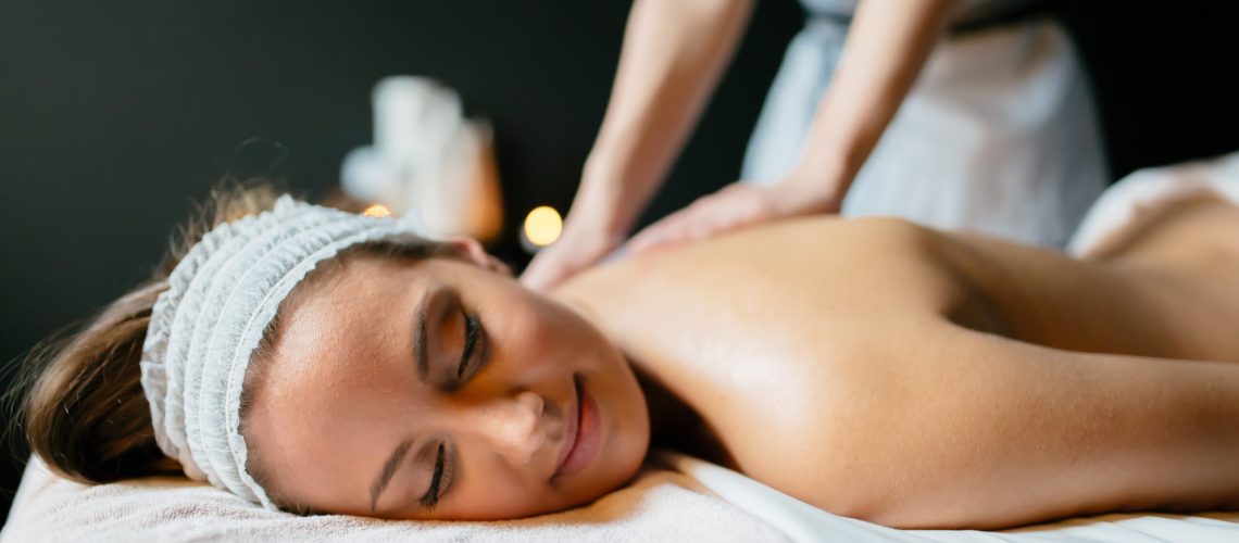 Beautiful young woman enjoying massage and rejuvenating