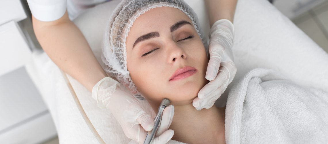 Face Skin Care. Close-up Of Woman Getting Facial Hydro Microdermabrasion Peeling Treatment At Cosmetic Beauty Spa Clinic. Hydra Vacuum Cleaner. Exfoliation, Rejuvenation And Hydratation. Cosmetology.